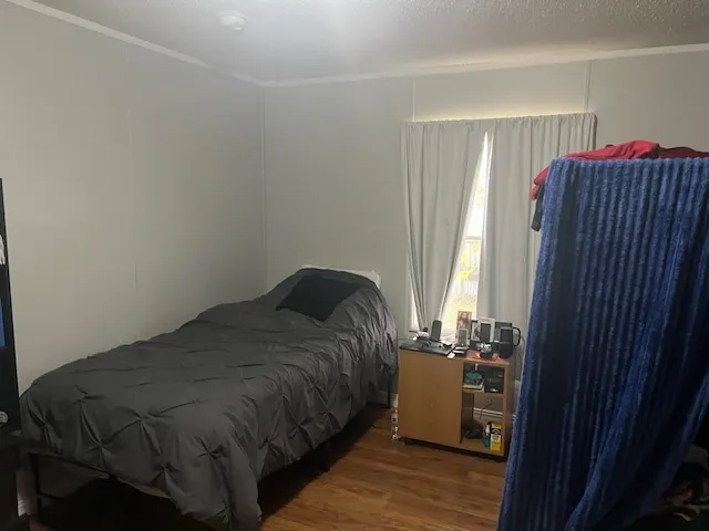 a bedroom with a bed and a mirror