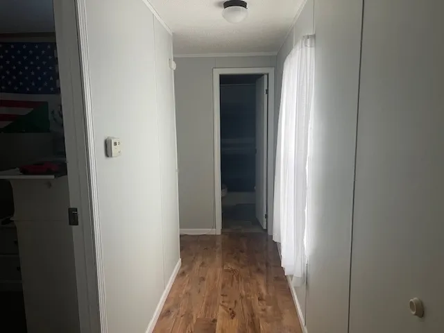 a view of a hallway with wooden floor