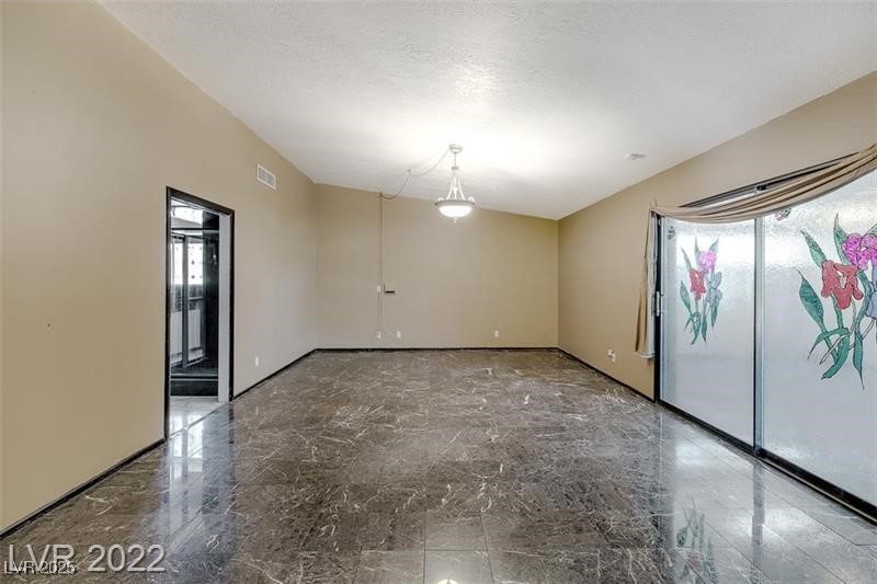 2249 Darwin Circle Henderson, NV 89014 - Photo 15 of 24 Spare room with healthy amount of natural light and marble tiled flooring