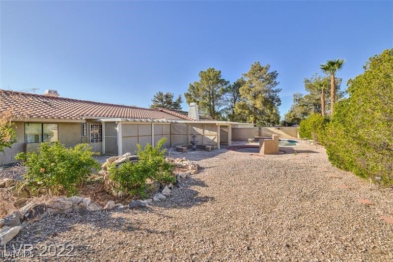2249 Darwin Circle Henderson, NV 89014 - Photo 20 of 24 Back of property with a tile roof, a chimney, and stucco siding