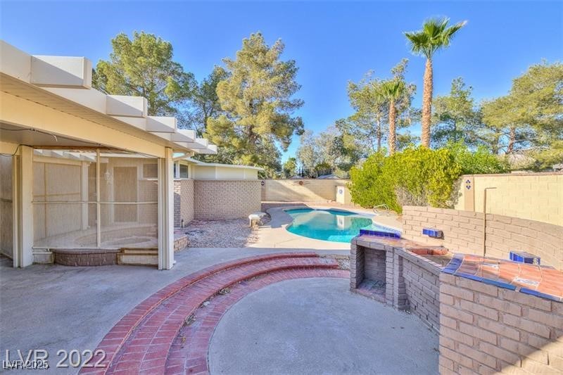 2249 Darwin Circle Henderson, NV 89014 - Photo 21 of 24 View of swimming pool featuring a fenced backyard, a patio area, and a jacuzzi