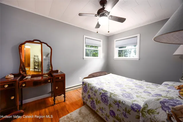 a bedroom with a bed and a mirror on dresser