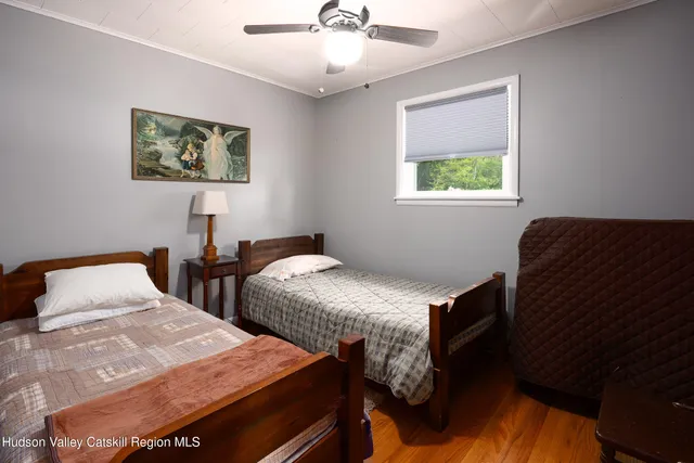 a bedroom with two beds and a chandelier