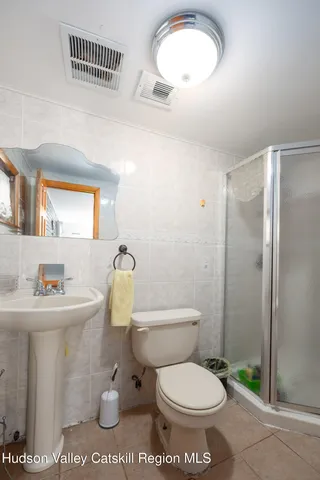 a bathroom with a toilet a sink and a mirror