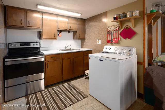 a kitchen with a sink stove and refrigerator