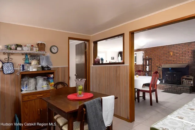 a view of a dining room with furniture and a kitchen