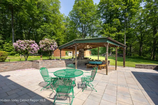 a view of patio with table and chairs under an umbrella
