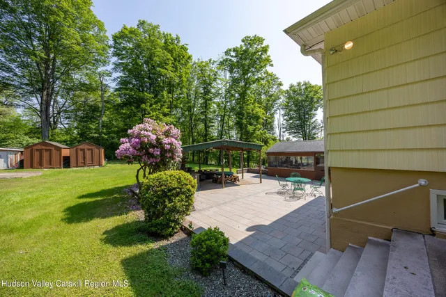 a view of backyard with a garden and entertaining space