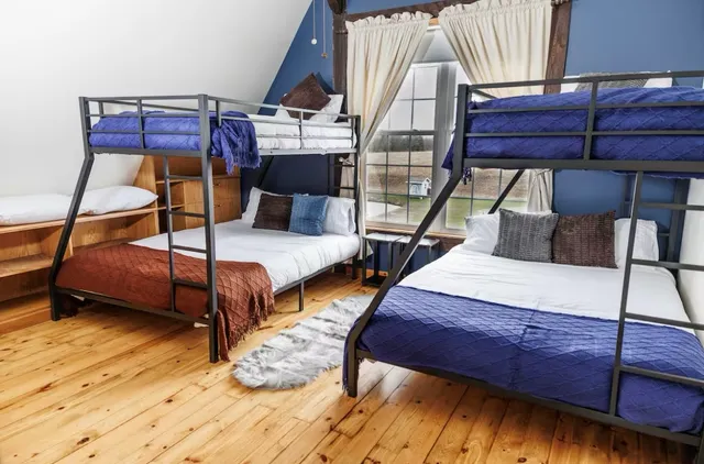 a bedroom with bed and wooden floor