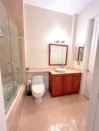 a bathroom with a toilet a sink and mirror