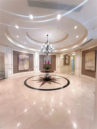 a dining room with furniture and a chandelier
