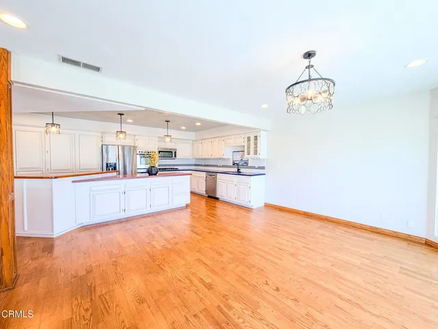 a view of a kitchen with kitchen island and wooden floor