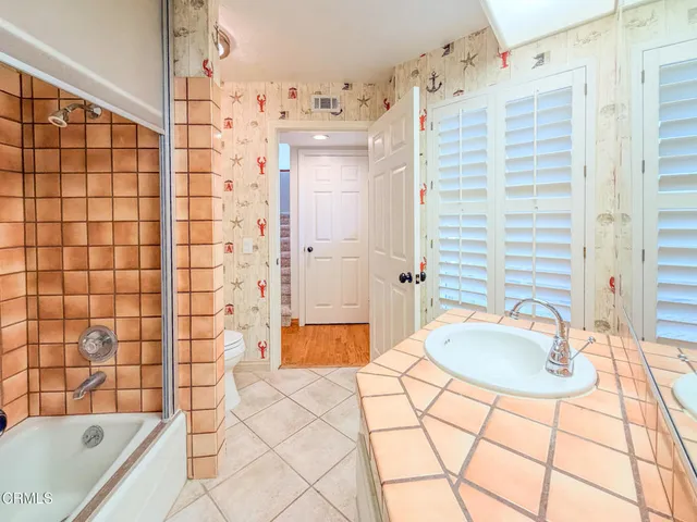 a bathroom with a tub sink and shower