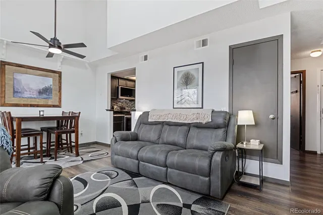 a living room with furniture and wooden floor