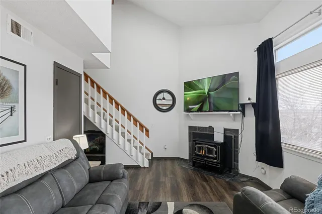 a view of a hallway with wooden floor and entryway