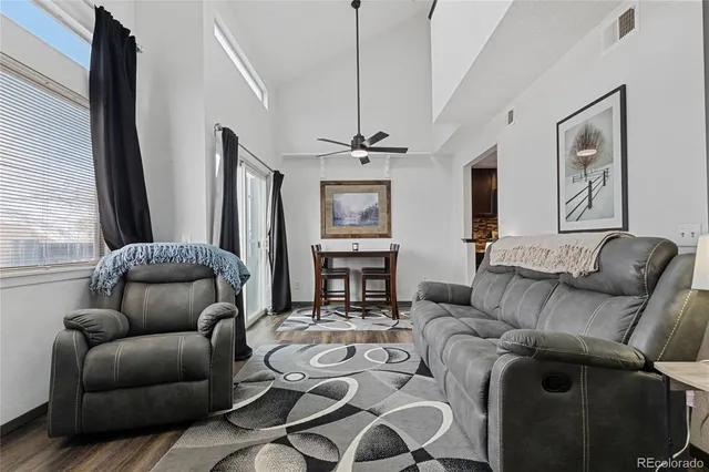 a living room with furniture a fireplace and a window