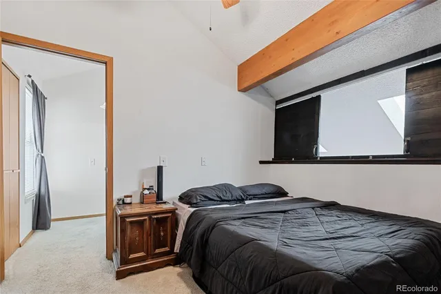 a bed sitting in a bedroom next to a window