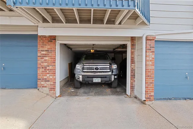 a bathroom with a granite countertop sink a toilet and mirror