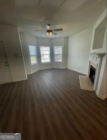 wooden floor in an empty room with a fireplace