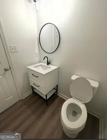 a bathroom with a sink mirror and toilet