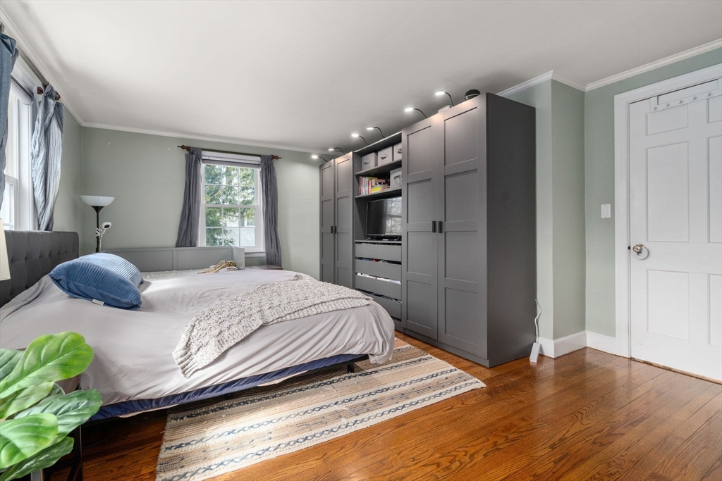339 Weston Road Wellesley, MA 02481 - Photo 14 of 32 a bedroom with a bed closet and a window