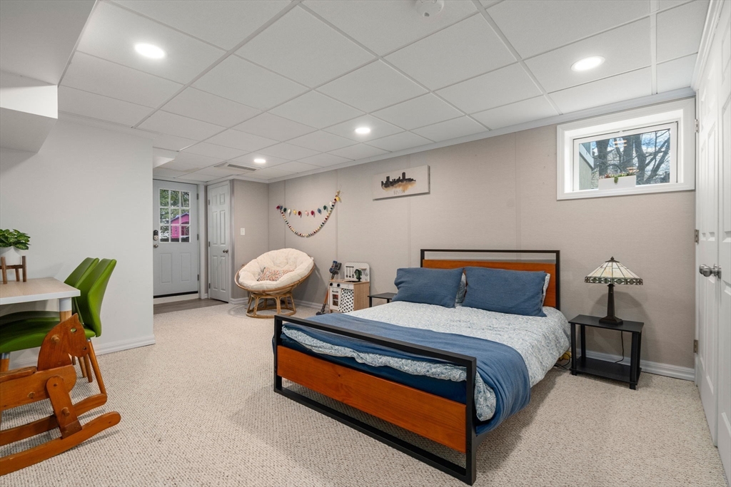 339 Weston Road Wellesley, MA 02481 - Photo 25 of 32 a bedroom with a bed and a chandelier