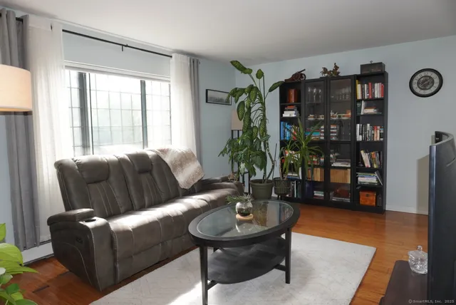 a living room with furniture and book shelf