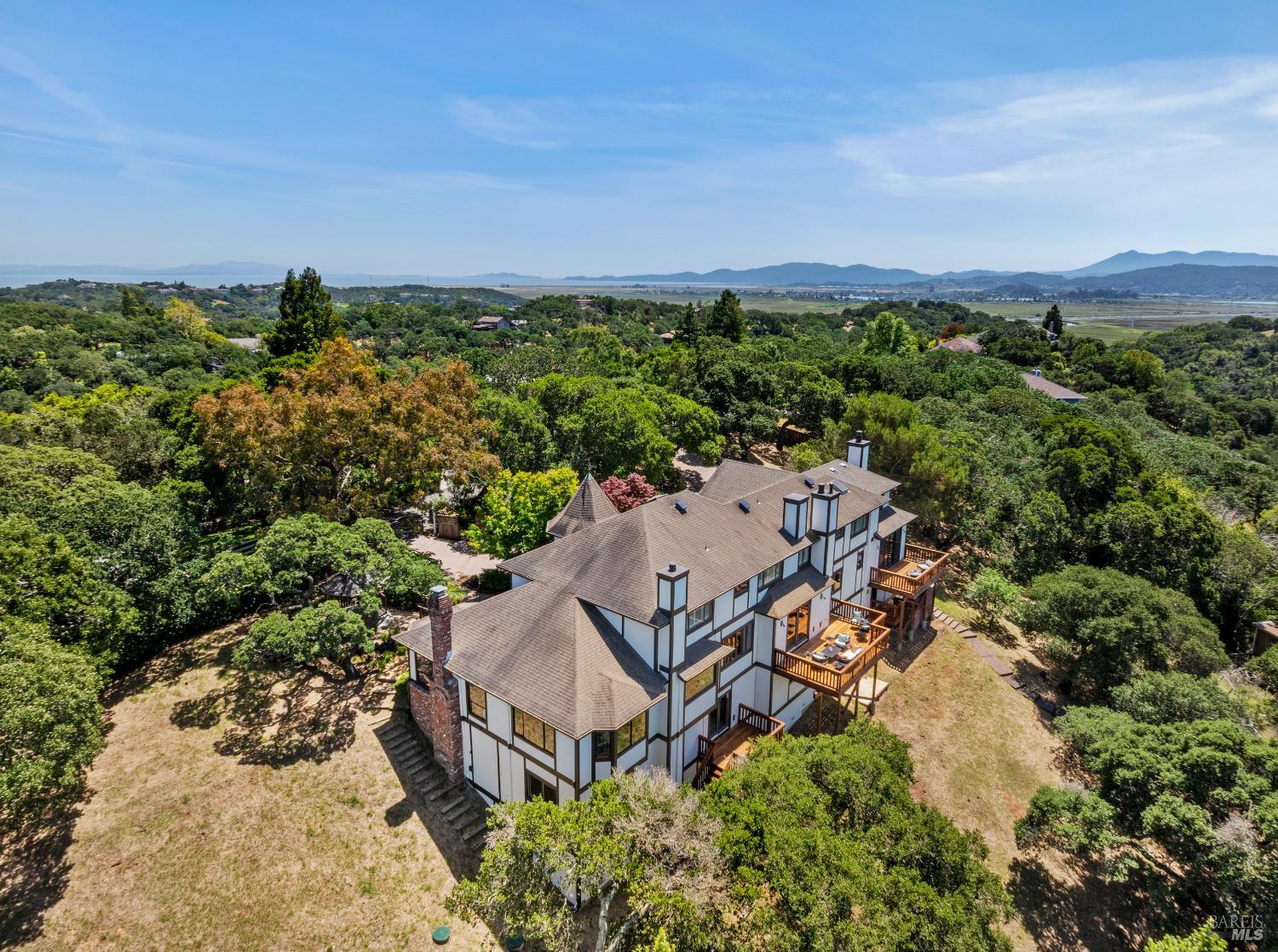 10 Lockton Lane Novato, CA 94945 - Photo 2 of 68 Set on gated Lockton Lane in Green Point, this private Novato residence is surrounded by mature trees, rolling hills, and a peaceful natural setting.