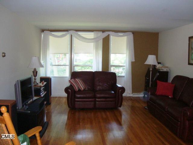 160 Fairfield Woods Road, Unit 66 Fairfield, CT 06825 - Photo 1 of 1 a living room with furniture rug and wooden floor