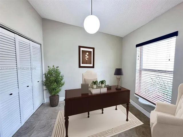 a kitchen with a sink a counter top space cabinets and a window