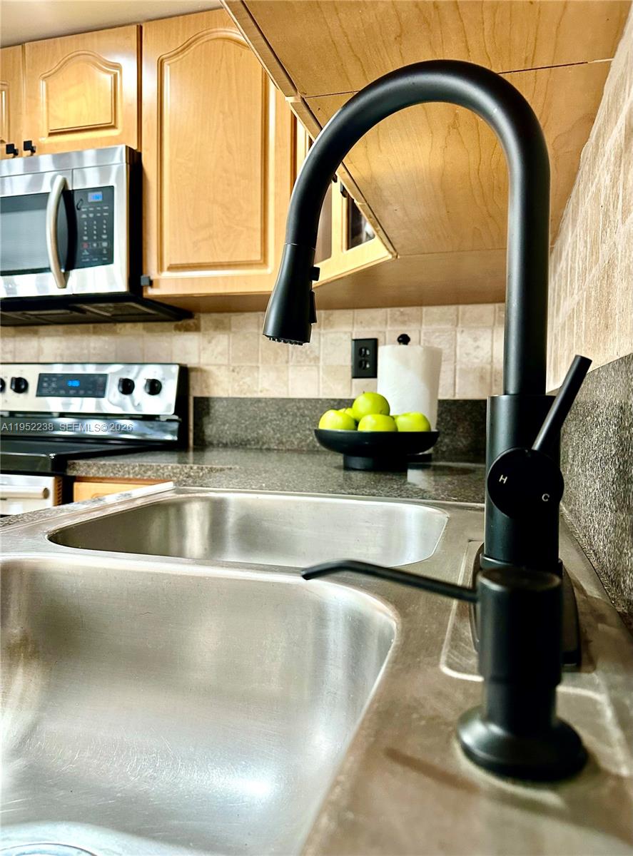 11117 Southwest 122nd Court Miami, FL 33186 - Photo 13 of 29 a kitchen with a sink a counter top space cabinets and a window