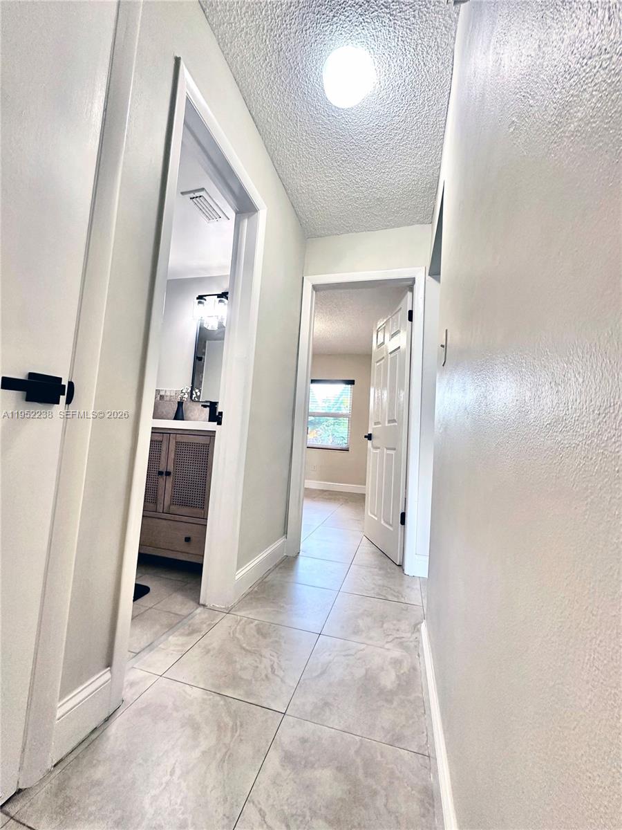 11117 Southwest 122nd Court Miami, FL 33186 - Photo 16 of 29 a view of a hallway with wooden floor