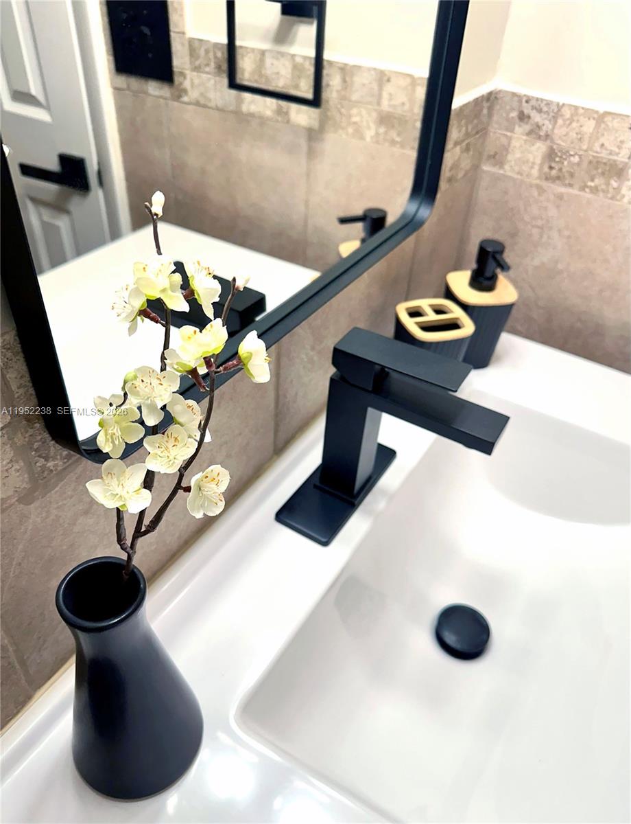 11117 Southwest 122nd Court Miami, FL 33186 - Photo 19 of 29 a bathroom with a sink and mirror