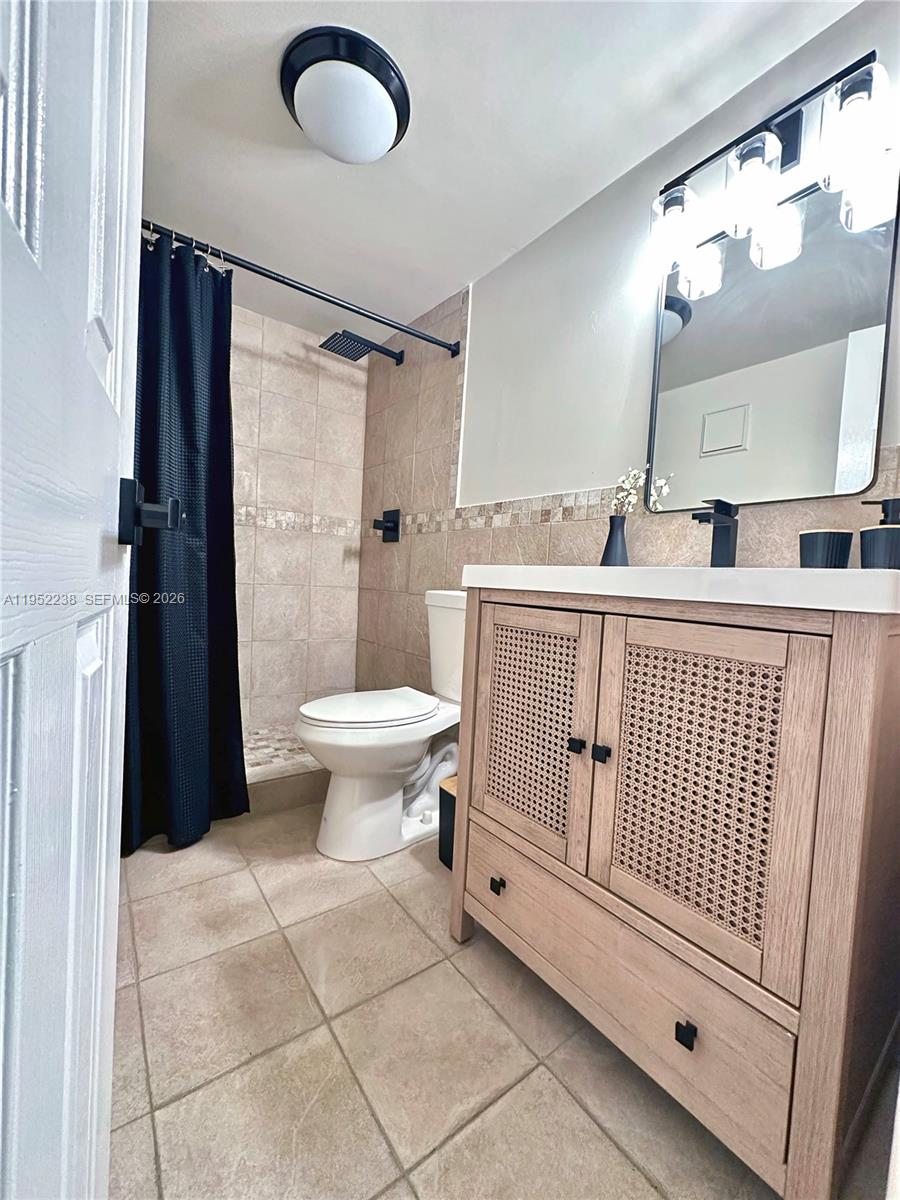 11117 Southwest 122nd Court Miami, FL 33186 - Photo 21 of 29 a bathroom with a sink toilet and a mirror