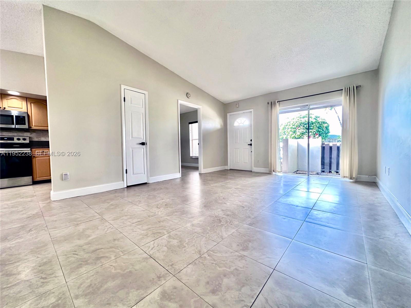 11117 Southwest 122nd Court Miami, FL 33186 - Photo 7 of 29 a view of a hallway with furniture and a window