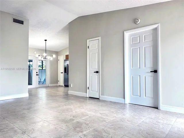a view of a big room with closet and windows