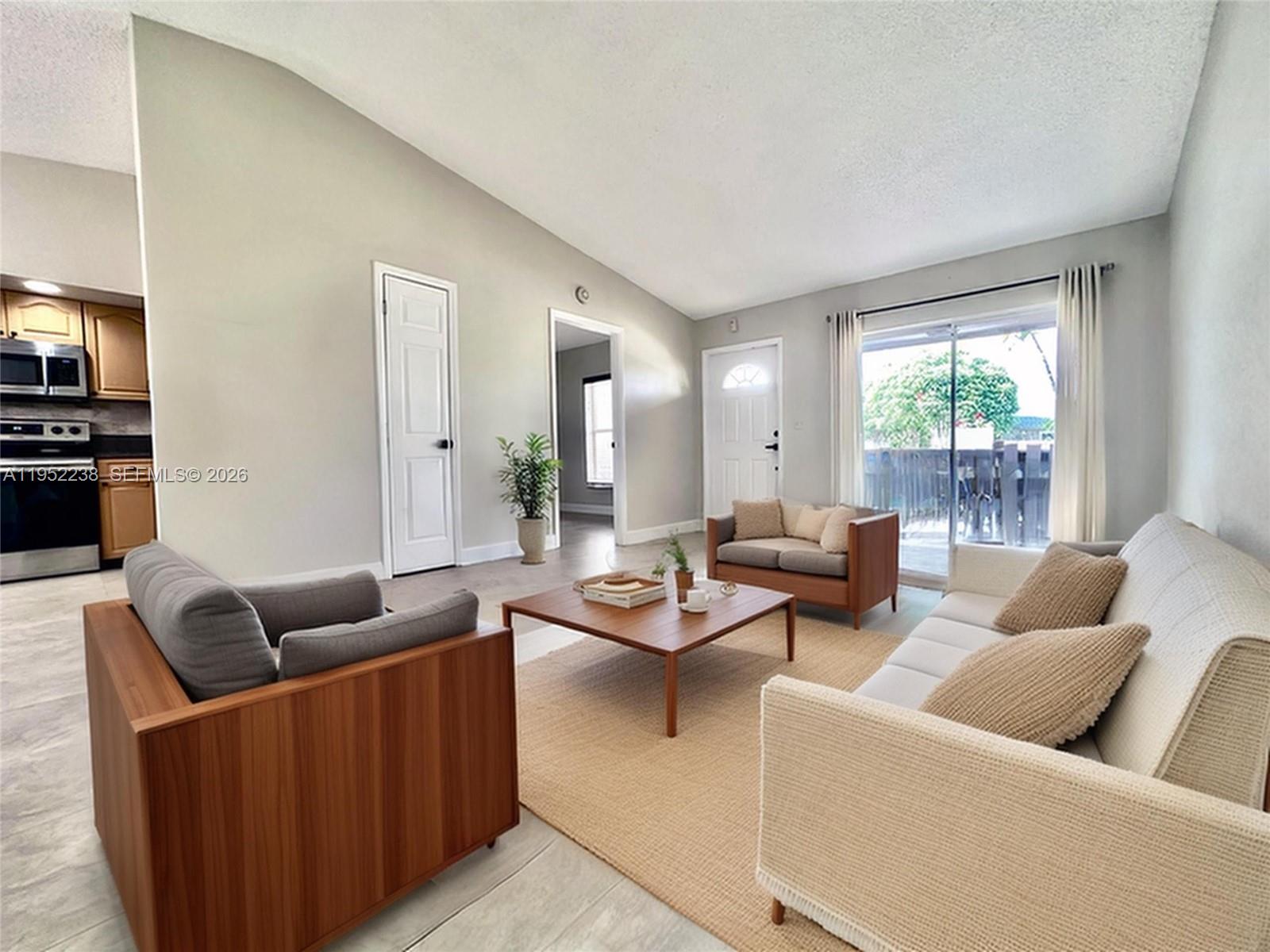 11117 Southwest 122nd Court Miami, FL 33186 - Photo 10 of 29 a living room with furniture and a large window