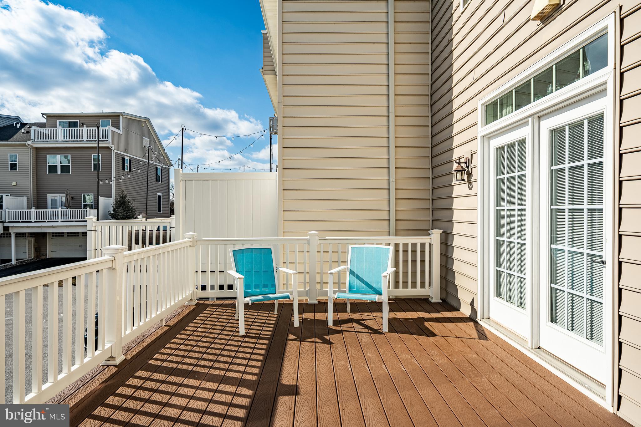 408 Atwater Drive Malvern, PA 19355 - Photo 15 of 49 a view of a balcony with two chairs and wooden floor