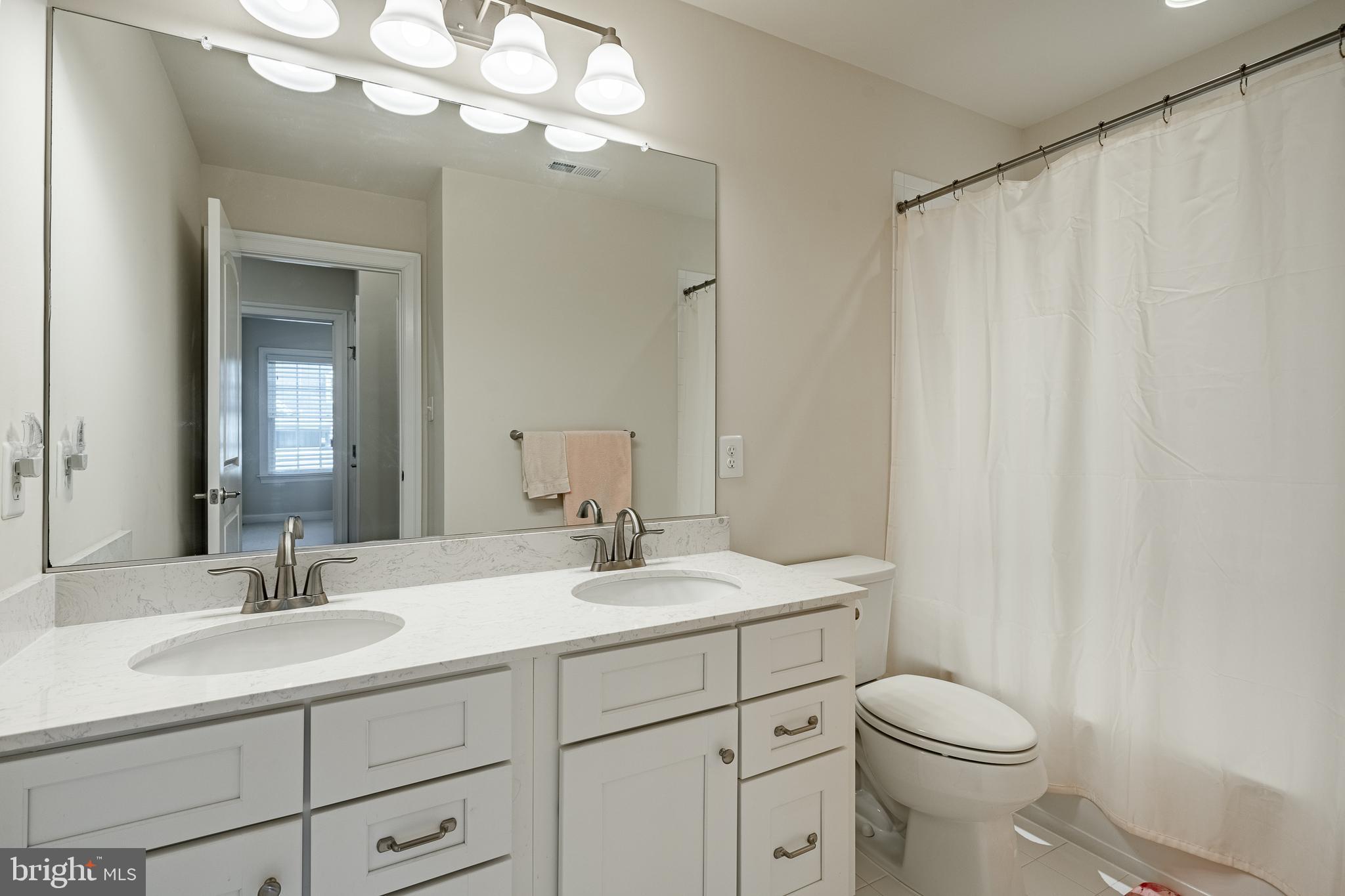 408 Atwater Drive Malvern, PA 19355 - Photo 26 of 49 a bathroom with a sink a toilet and a mirror
