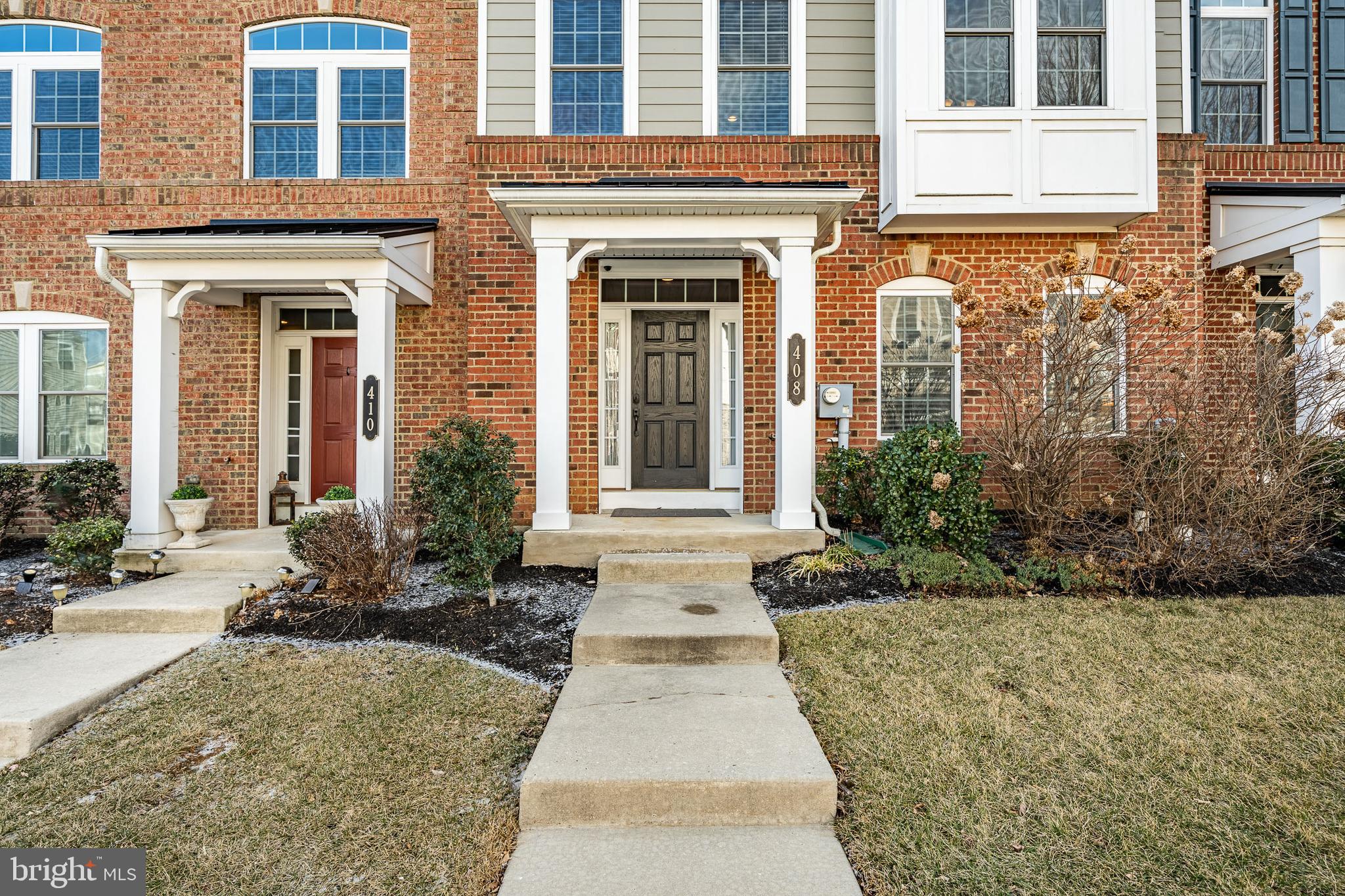 408 Atwater Drive Malvern, PA 19355 - Photo 3 of 49 front view of a brick house with potted plants