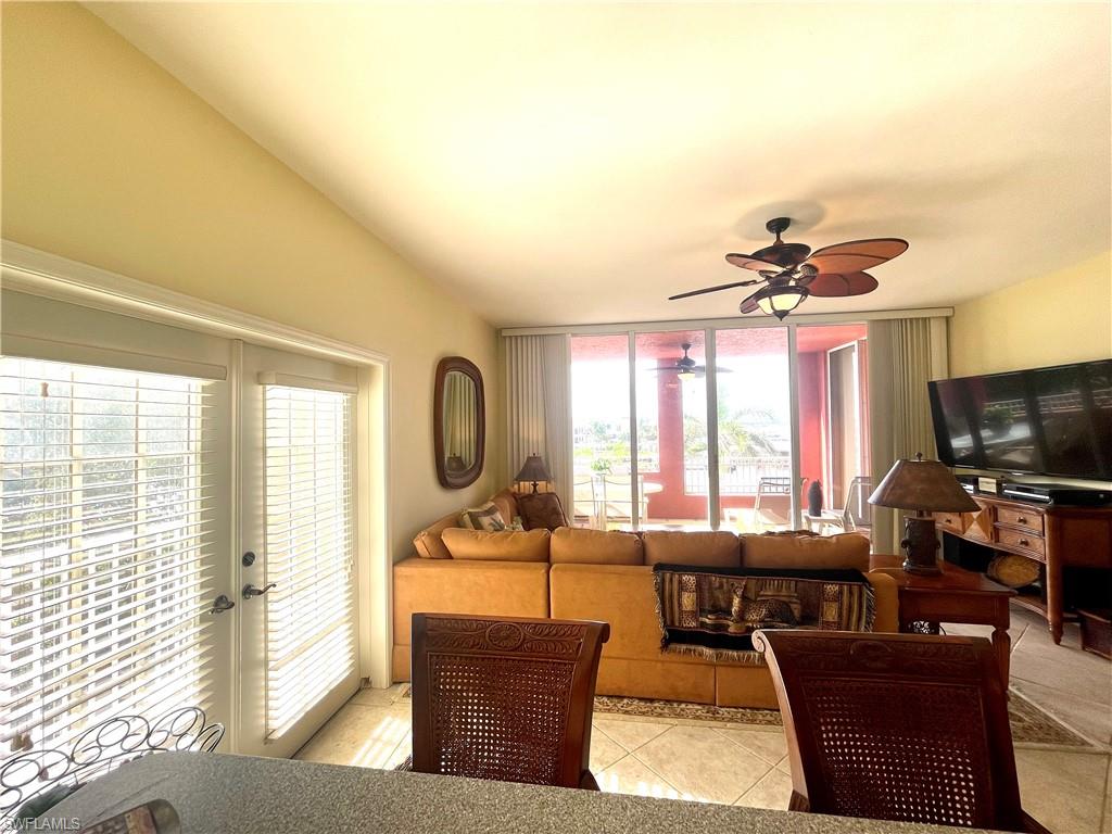 451 Bayfront Place, Unit 5311 Naples, FL 34102 - Photo 17 of 38 a living room with furniture a flat screen tv and a large window
