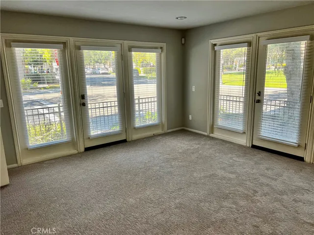 a view of an empty room with closet area