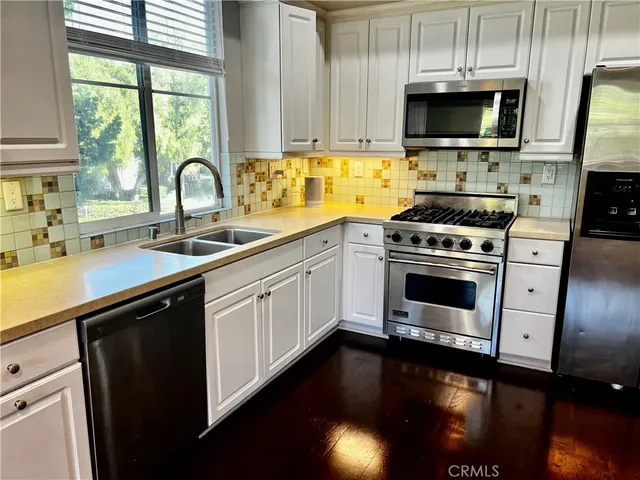 a kitchen with a sink stove and microwave
