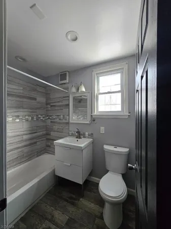 a bathroom with a toilet sink and bathtub