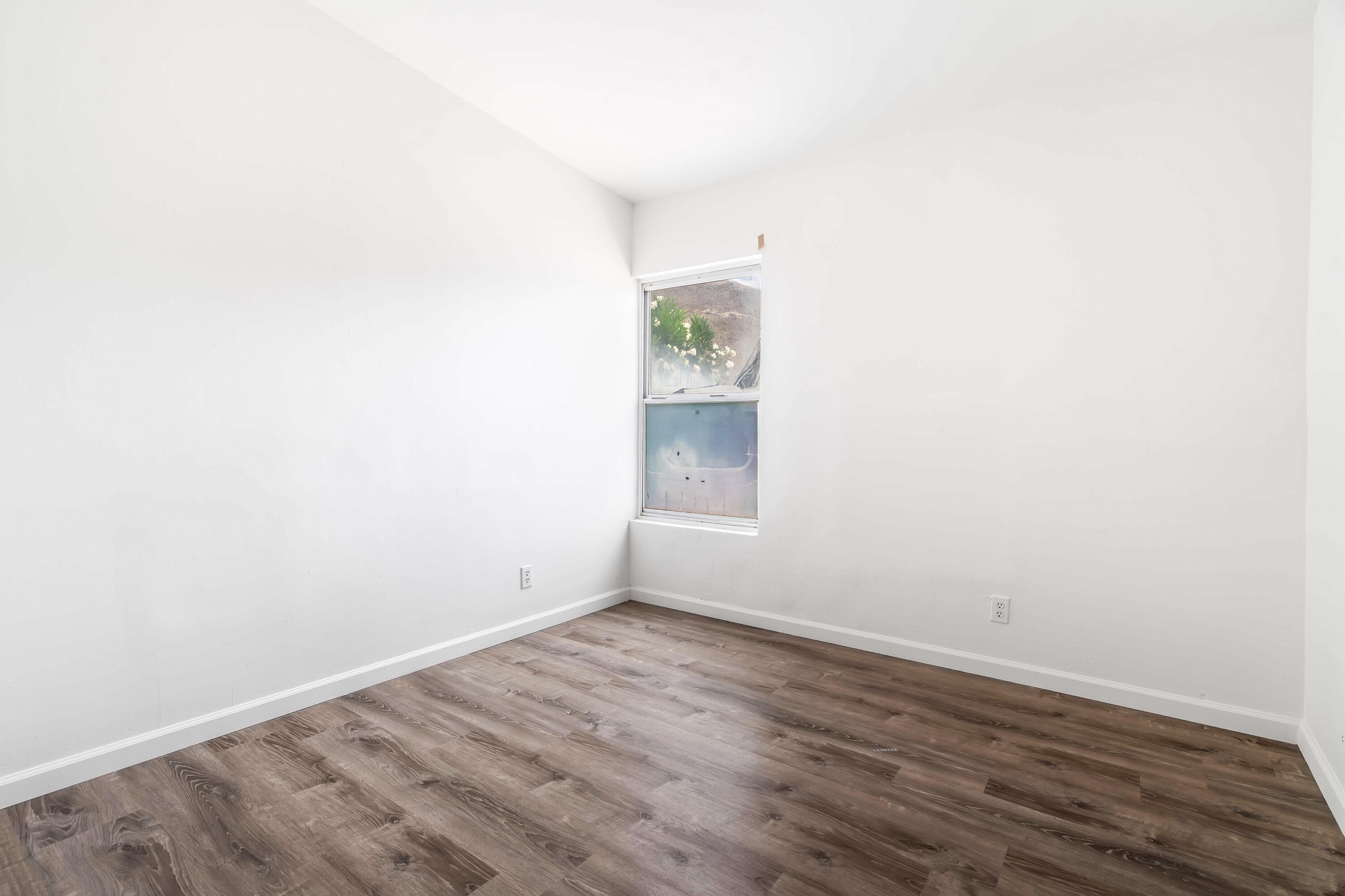 43831 Joshua Road Palm Desert, CA 92260 - Photo 15 of 42 a view of an empty room with wooden floor and a window