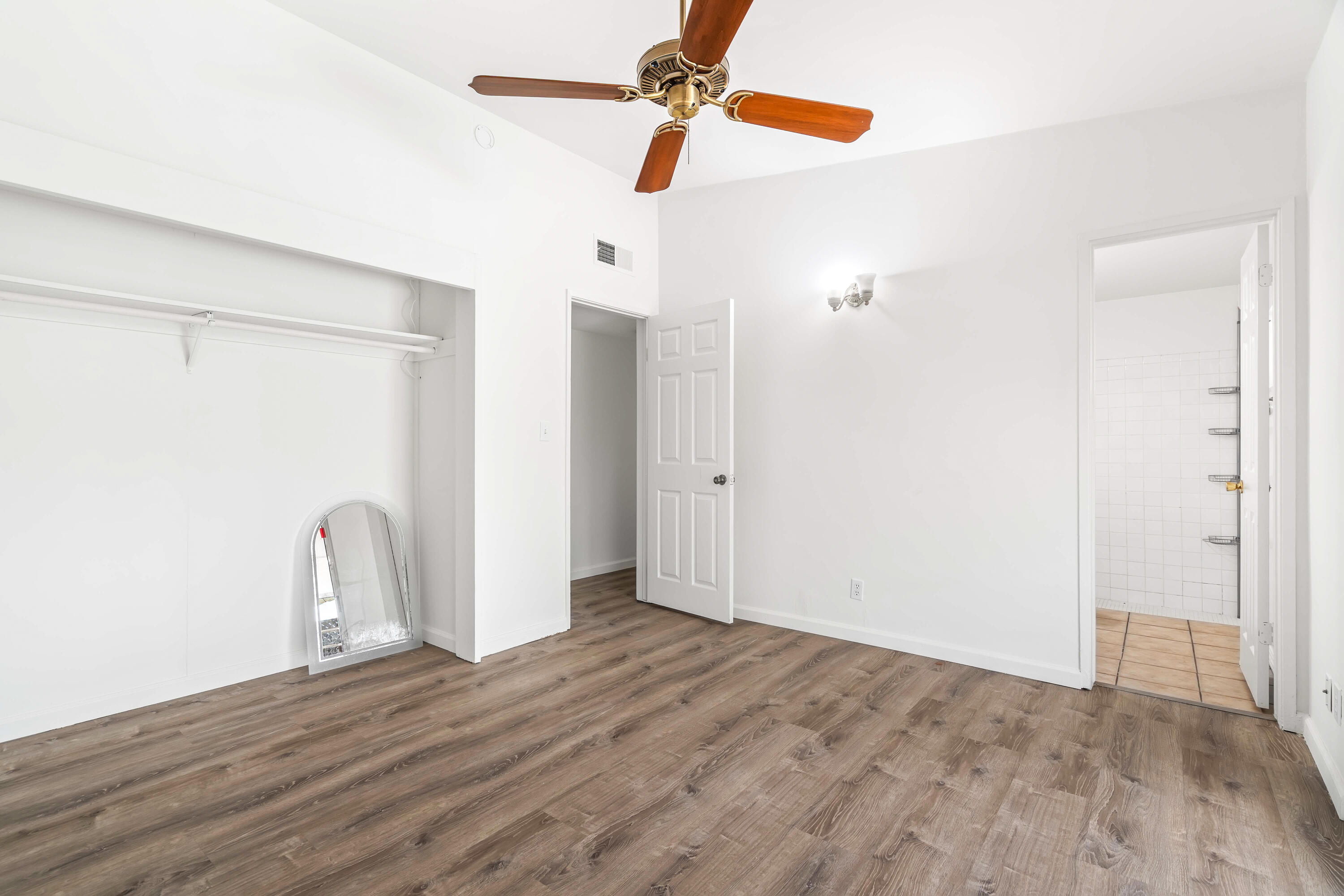 43831 Joshua Road Palm Desert, CA 92260 - Photo 19 of 42 a view of room with a ceiling fan and wooden floor
