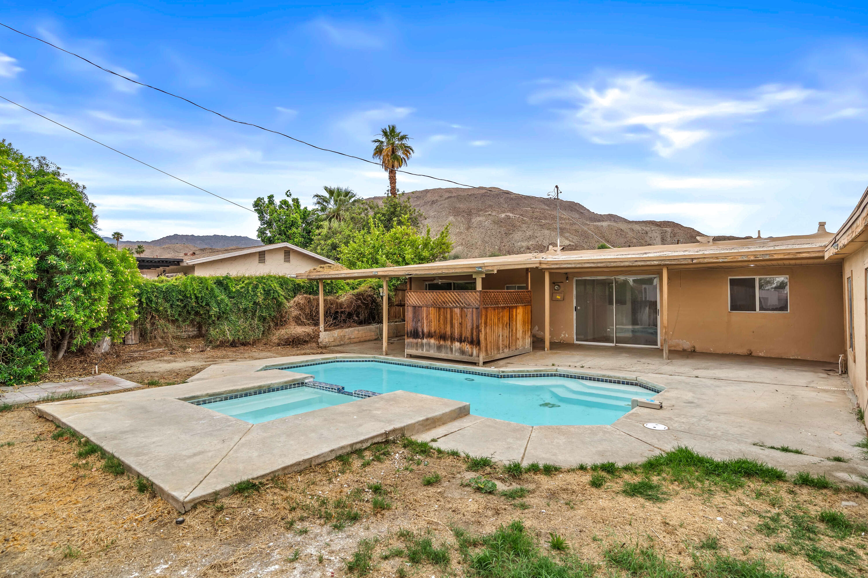 43831 Joshua Road Palm Desert, CA 92260 - Photo 21 of 42 a front view of a house with a yard and potted plants