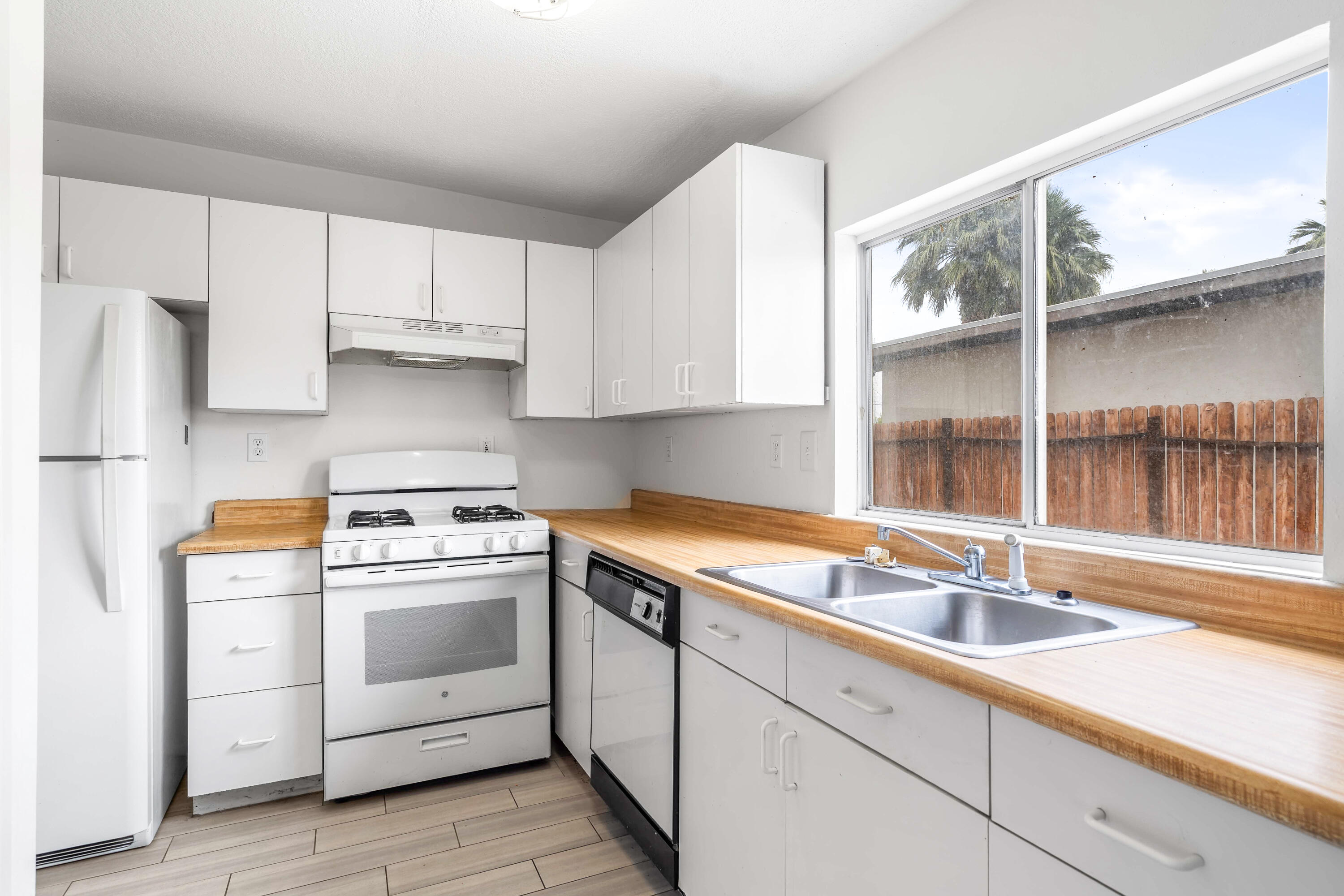 43831 Joshua Road Palm Desert, CA 92260 - Photo 33 of 42 a kitchen with a sink stove and cabinets