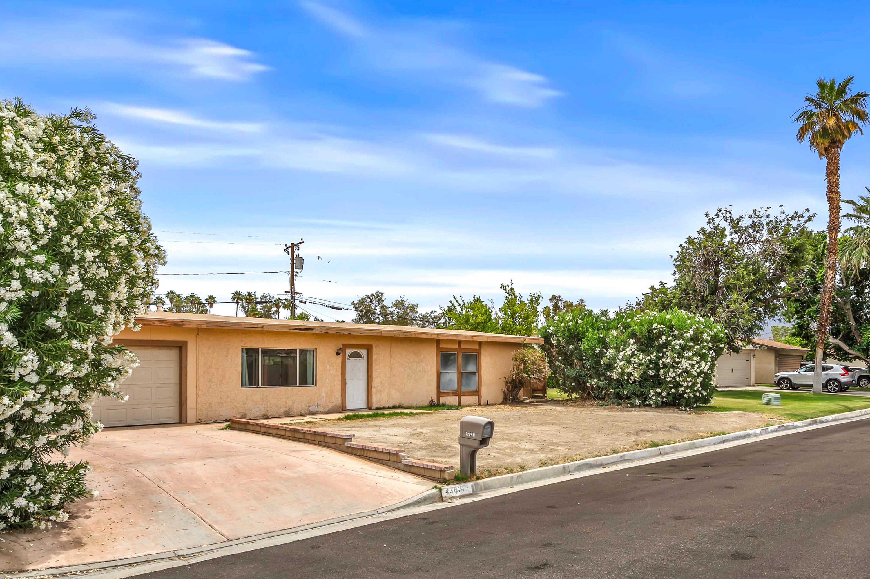 43831 Joshua Road Palm Desert, CA 92260 - Photo 39 of 42 a front view of a house with a yard and garage
