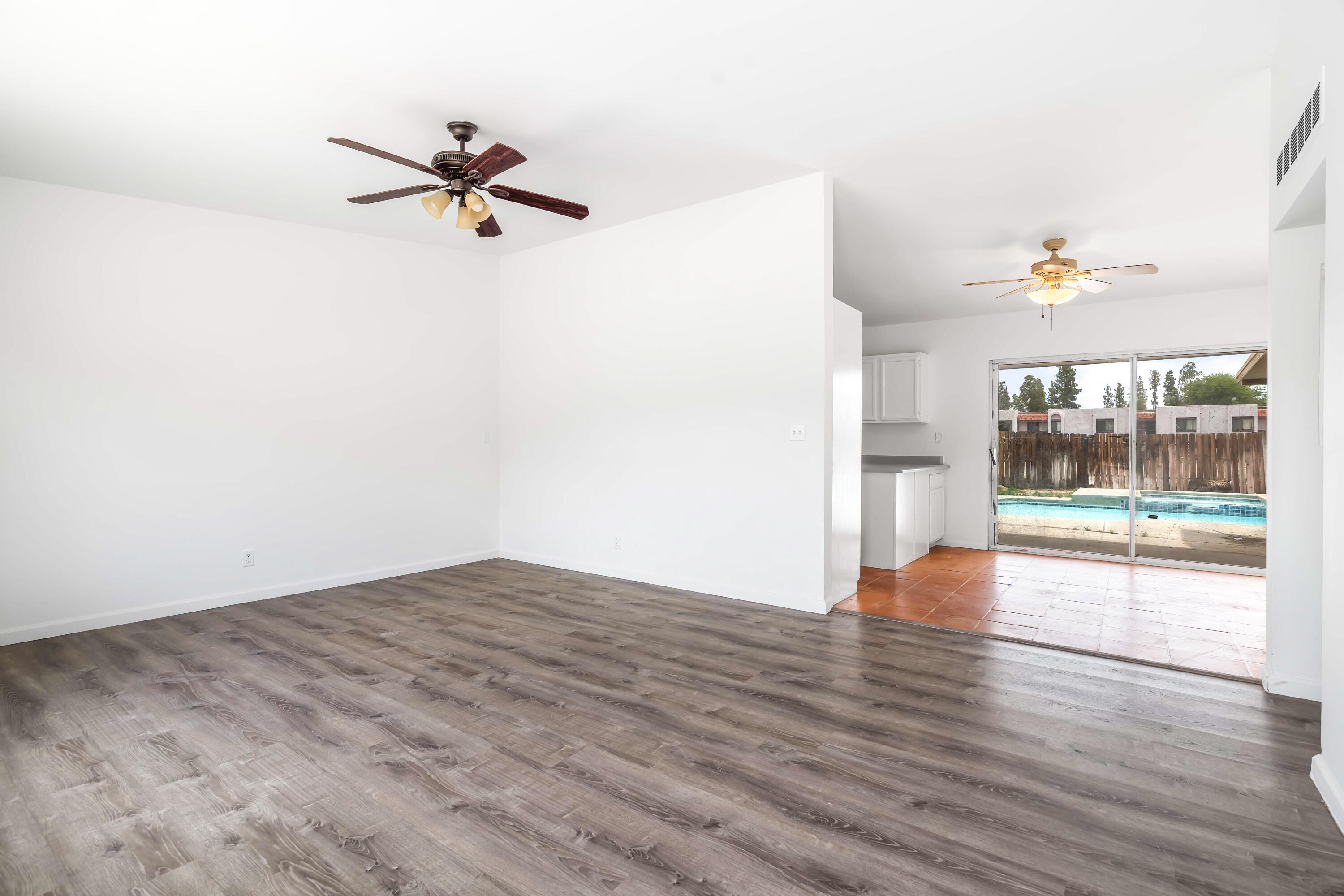 43831 Joshua Road Palm Desert, CA 92260 - Photo 4 of 42 an empty room with wooden floor and windows